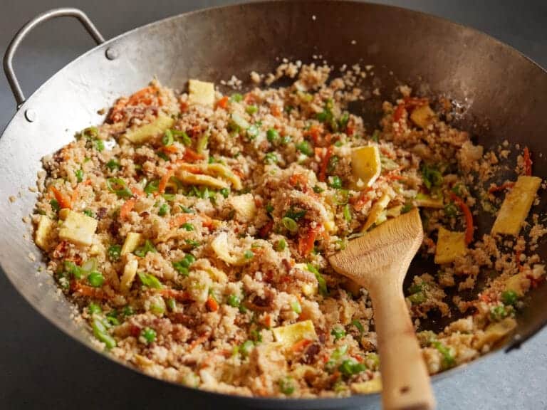 Chicken Cauliflower Fried Rice with vegetables and sesame seeds in a skillet