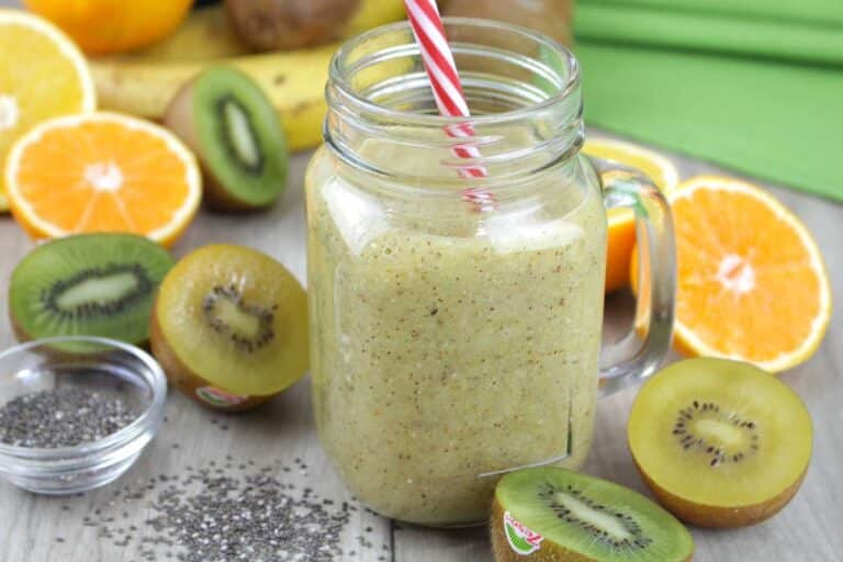 Refreshing Kiwi Agua Fresca in a glass with ice, lime slices, and fresh kiwi garnish for a tropical summer drink