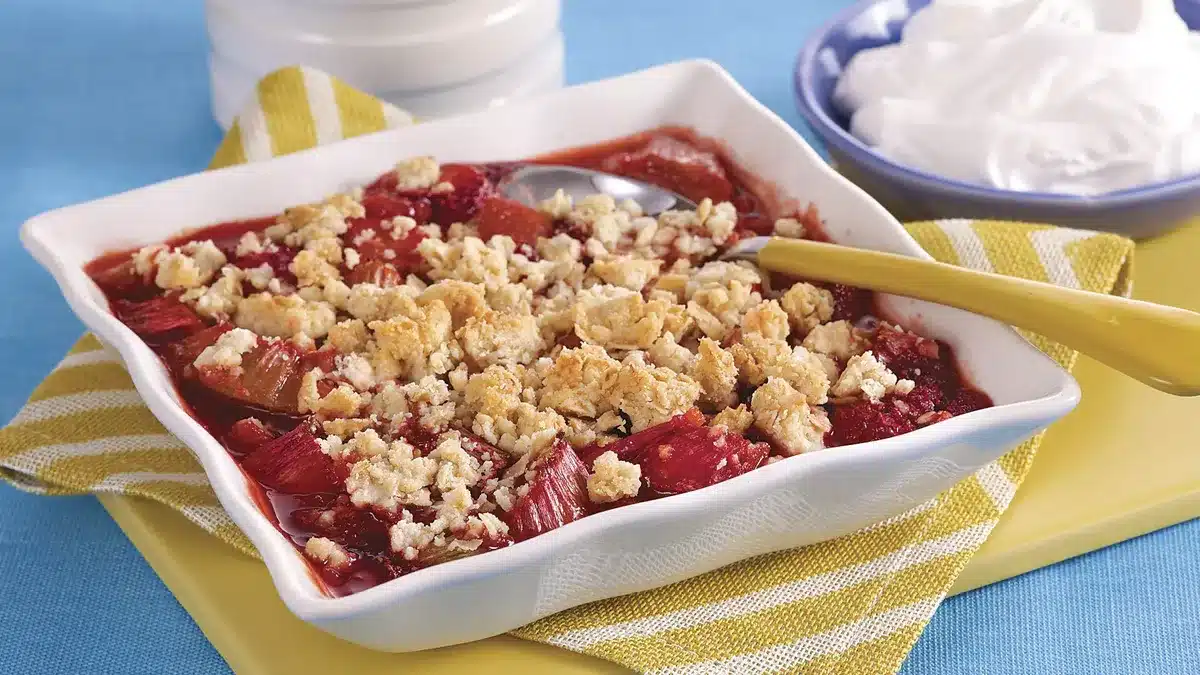 Maple-Sweetened Strawberry Rhubarb Crisp in a baking dish with a golden oat topping.