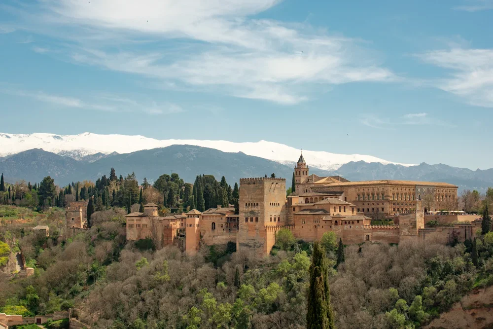 Aerial view of the Alhambra palace in Granada with city and mountains in background