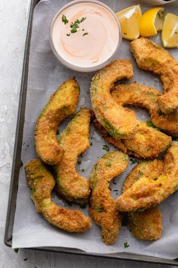 golden brown avocado fries with creamy center on a white plate