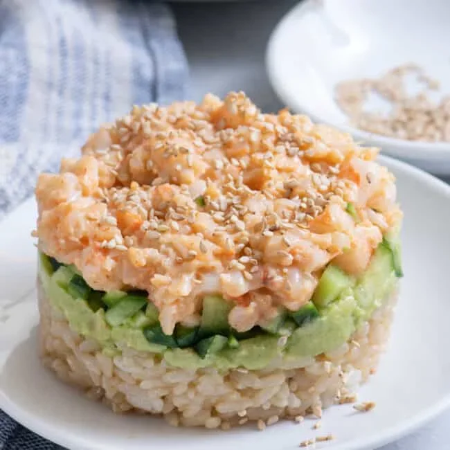 layered shrimp sushi stack with avocado and cucumber in a glass