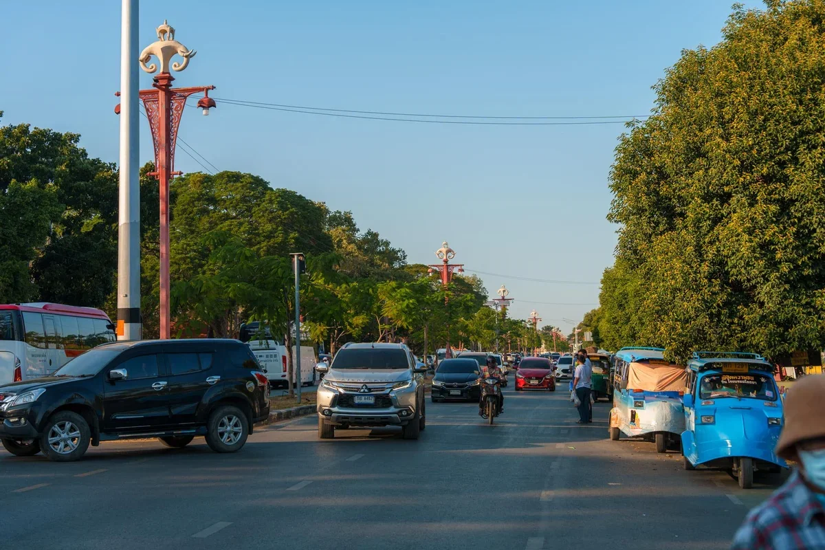 traveler inspecting a rented scooter in Ayutthaya before riding