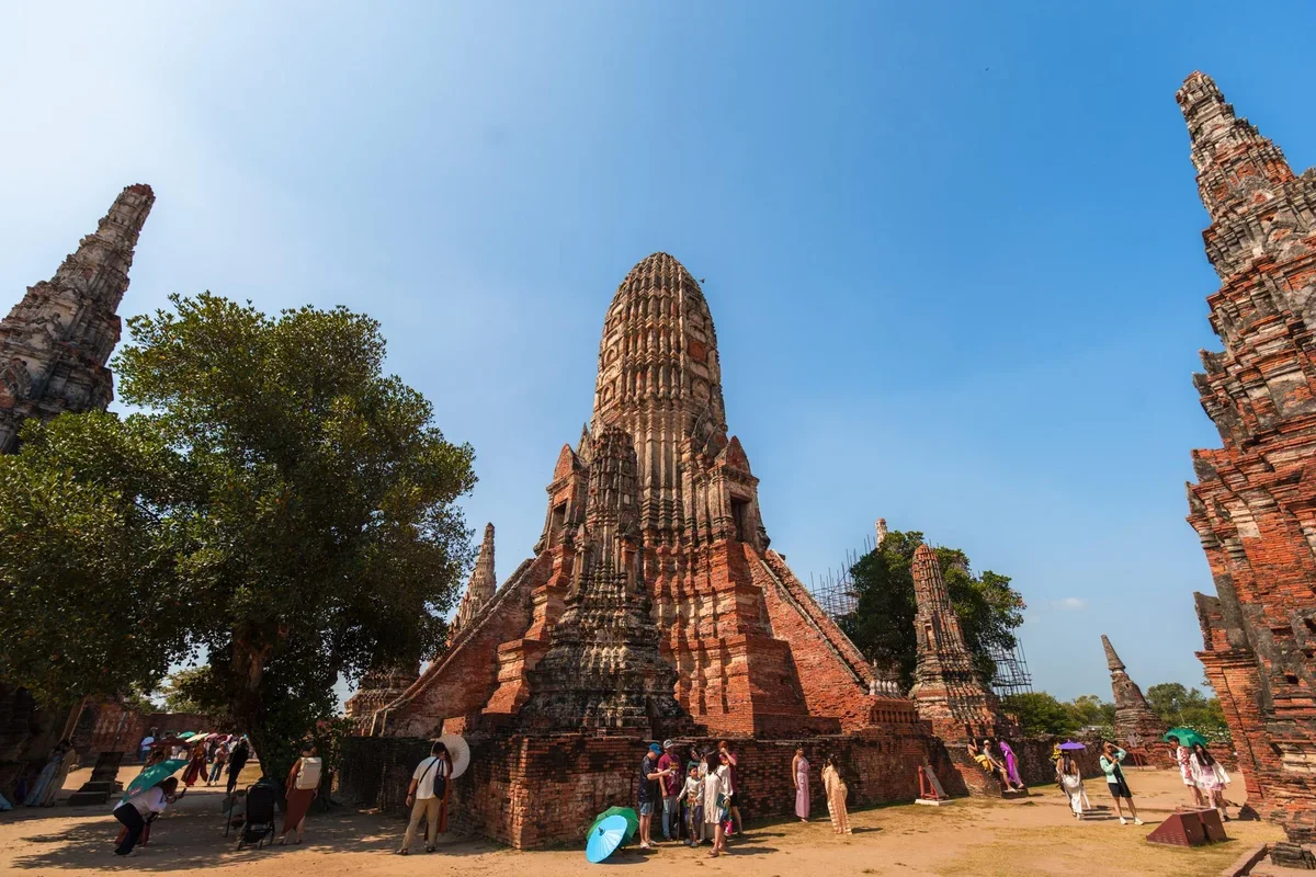 family exploring Ayutthaya historical park with ancient temples in background