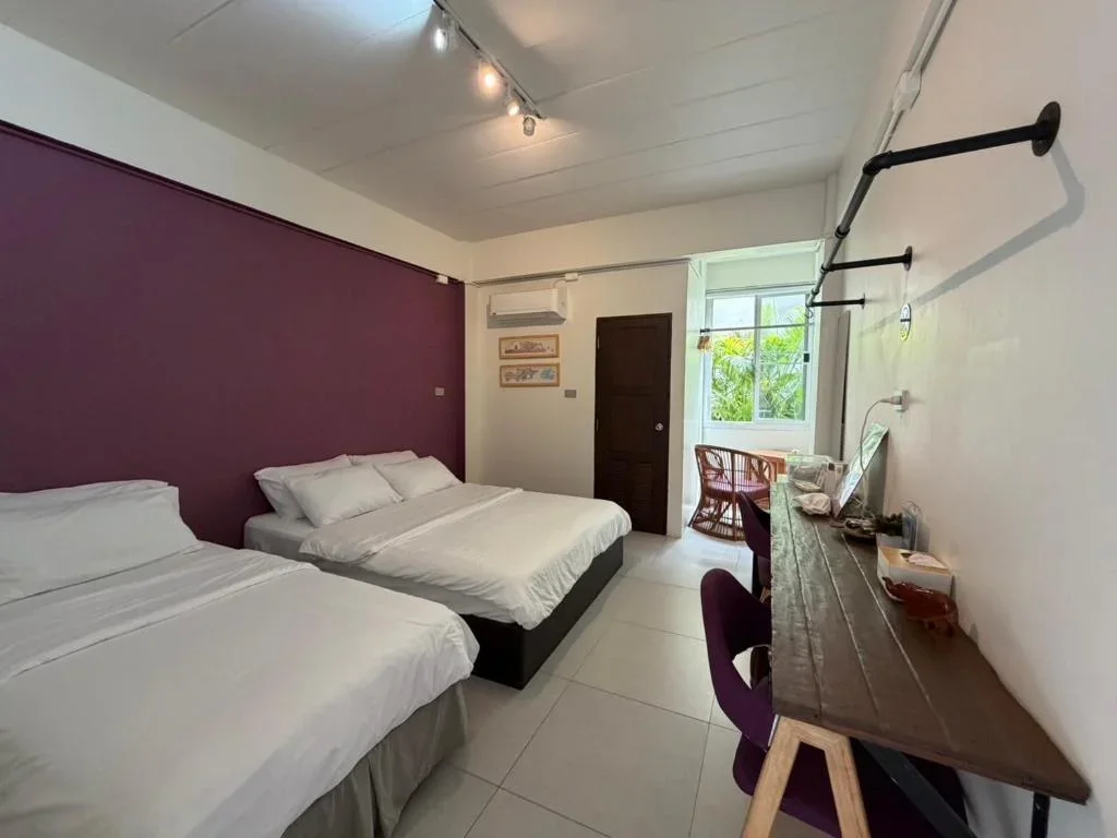Baiput Hometel family room with double bed, single bed, and mini-fridge for budget travelers