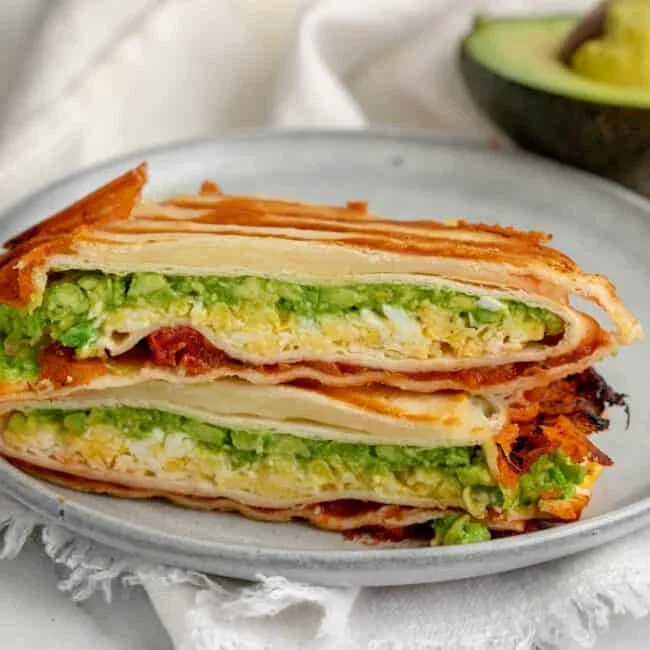 folded tortilla wrap with four different breakfast fillings