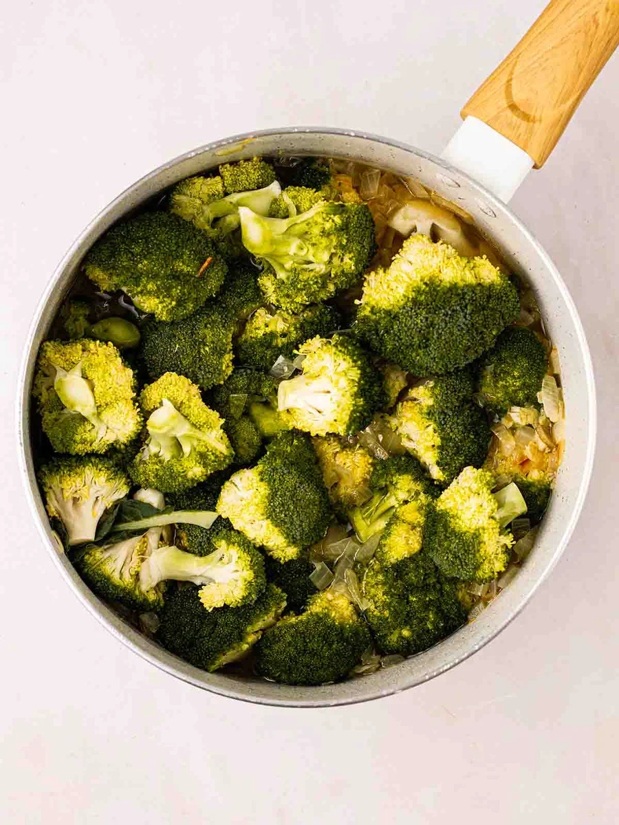 Vegetables and stock simmering in pot for cheese soup