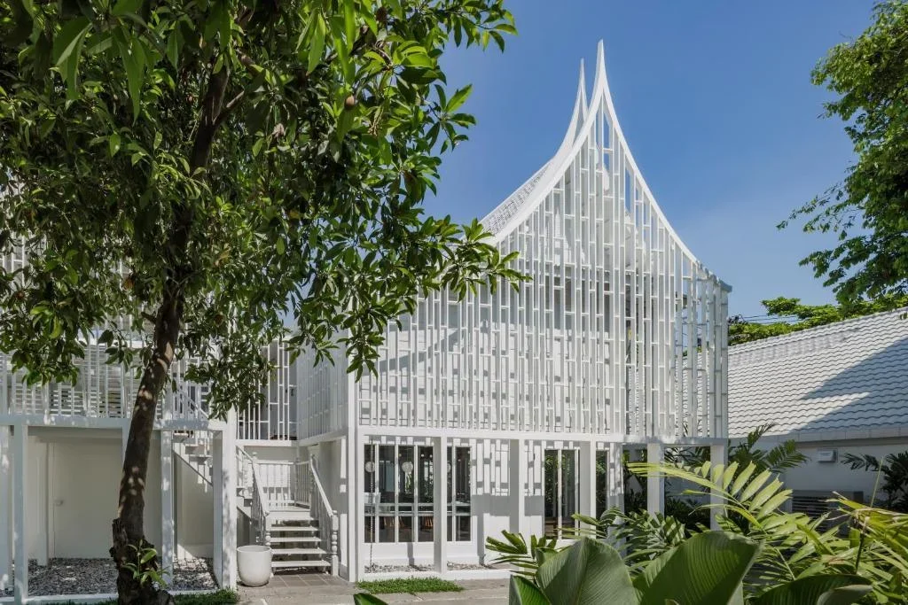 distinctive white exterior of Busaba Ayutthaya Hotel near the river