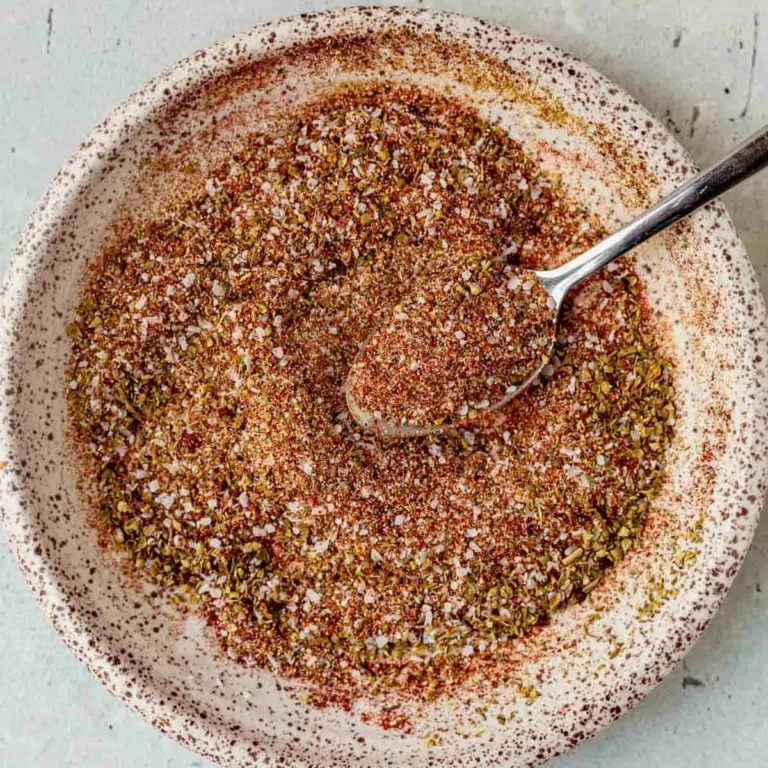 homemade carnitas seasoning mix with chili powder, cumin, and paprika in a bowl