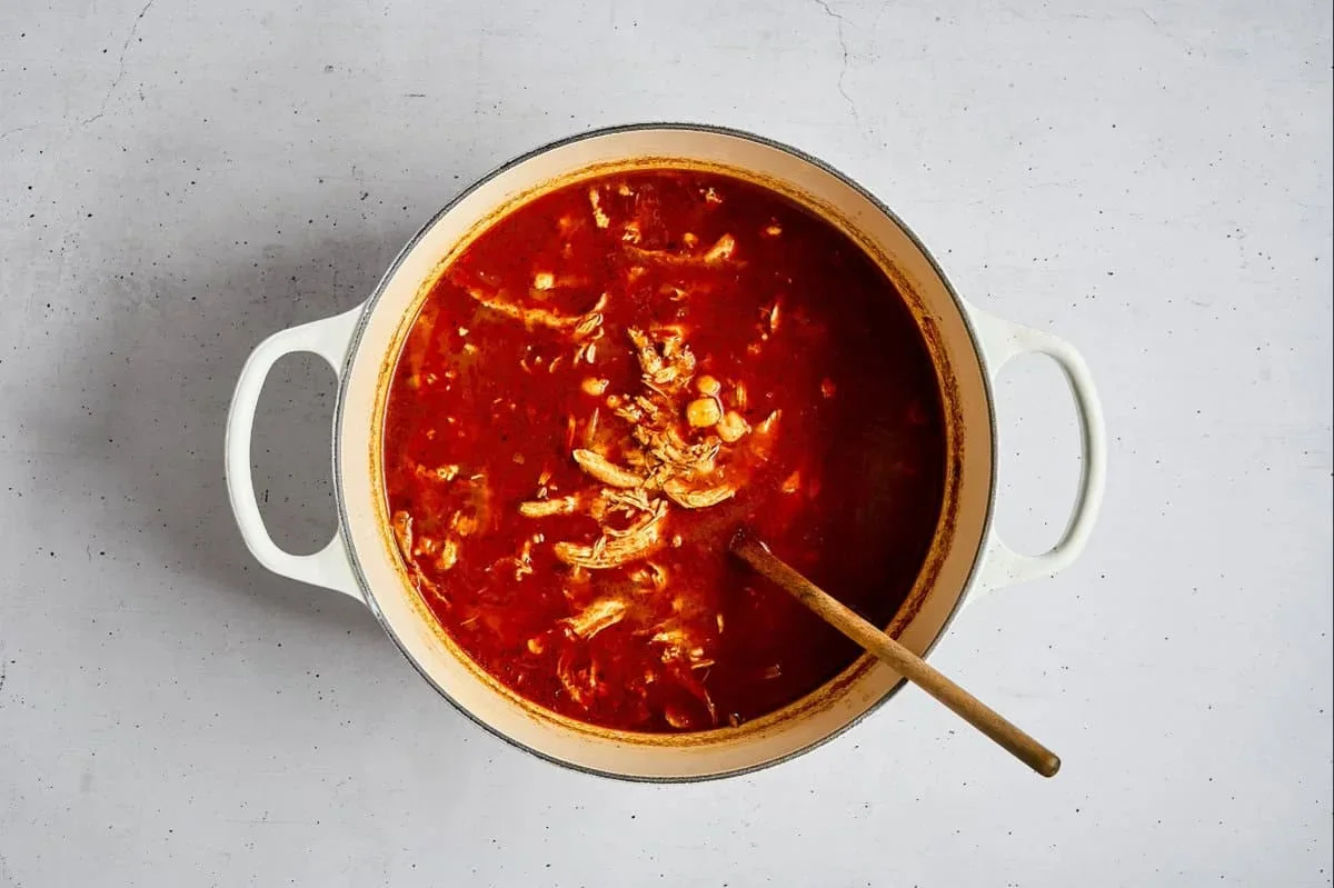chicken pozole rojo simmering with hominy in red chili broth