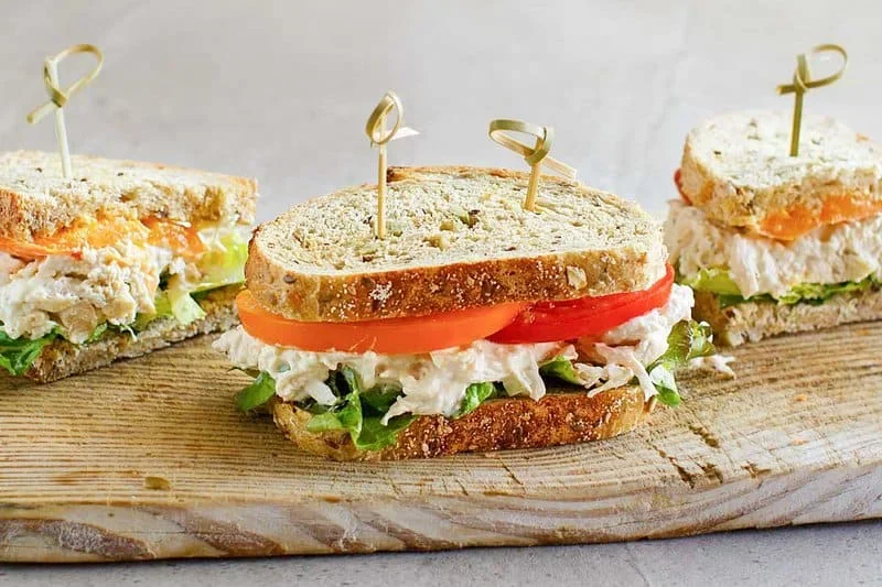 17 Spring Brunch Salads That Feel Fresh 7 creamy chicken salad with celery in a white bowl, copycat Chicken Salad Chick recipe