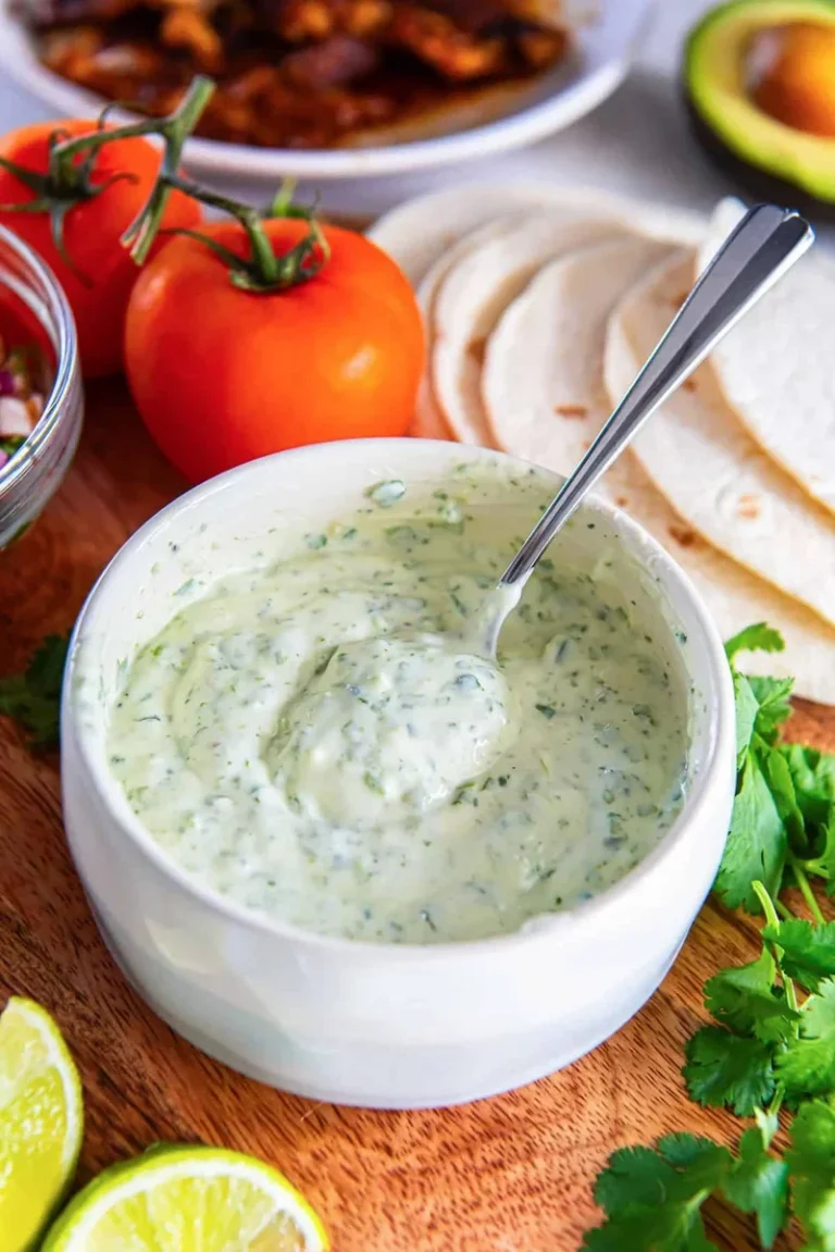 creamy cilantro lime sauce in a bowl with fresh herbs