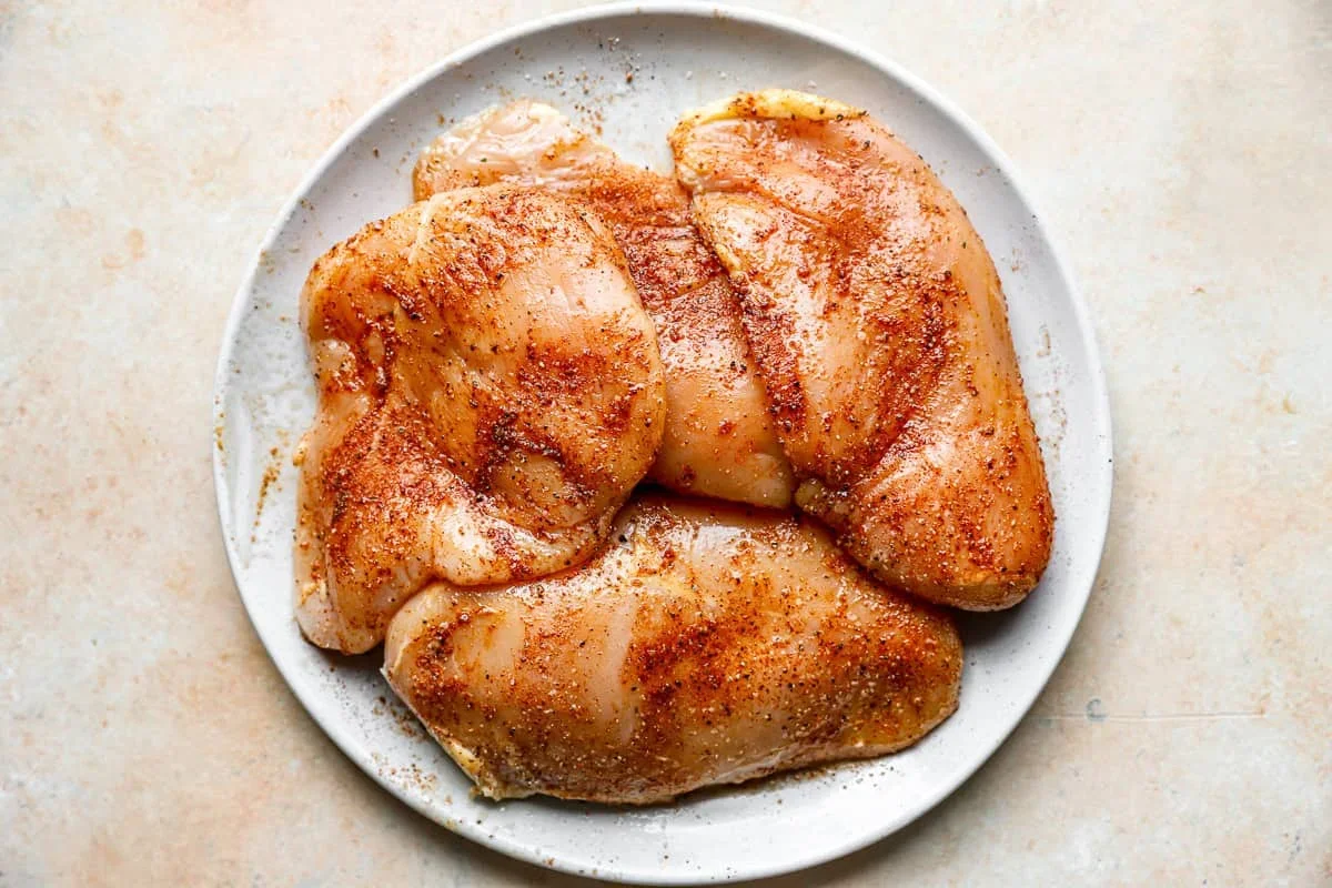 chicken breasts coated in red spice rub for cowboy chicken