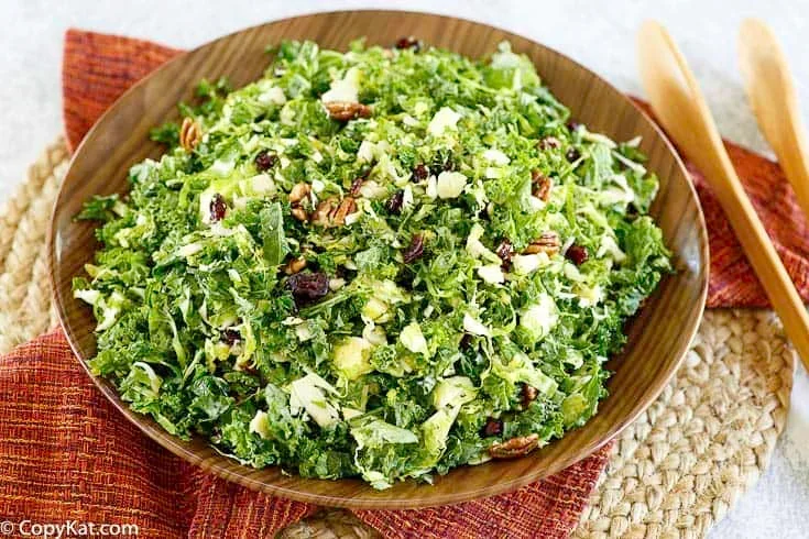 17 Spring Brunch Salads That Feel Fresh 1 Cracker Barrel Brussels Sprout and Kale Salad in a white bowl with cranberries and pecans