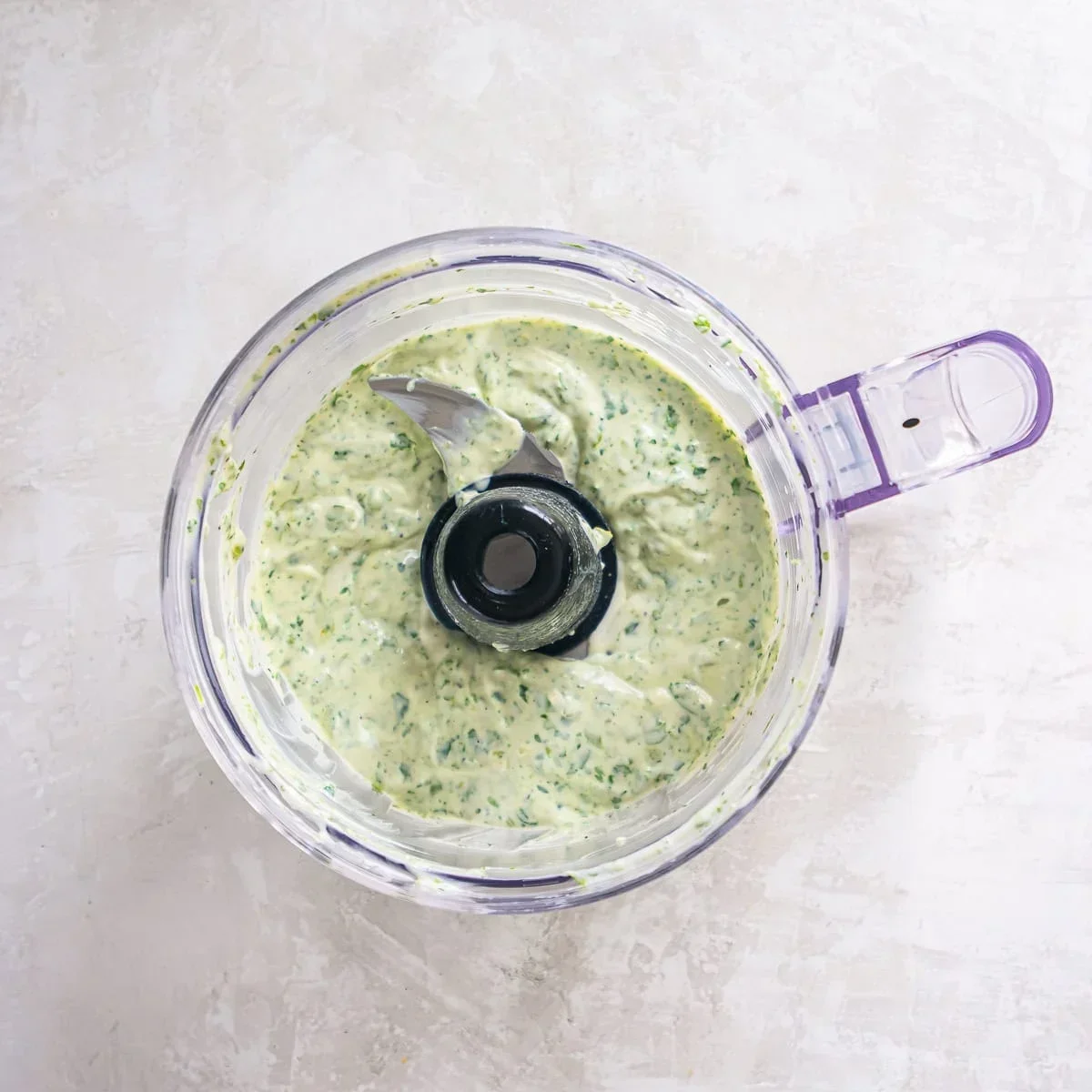 Smooth, creamy cilantro lime sauce in a bowl with a spoon