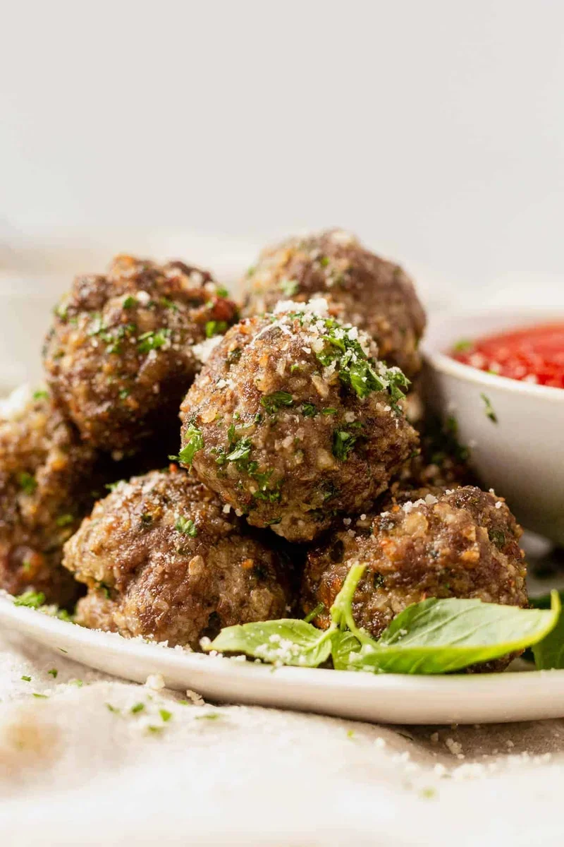 golden brown air fryer meatballs in the basket ready to serve