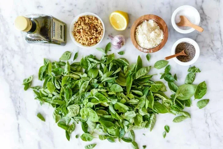 THE BEST Fresh Basil and Pine Nut Pesto - foodiecrush 2 vibrant green homemade basil pesto in glass jar with spoon
