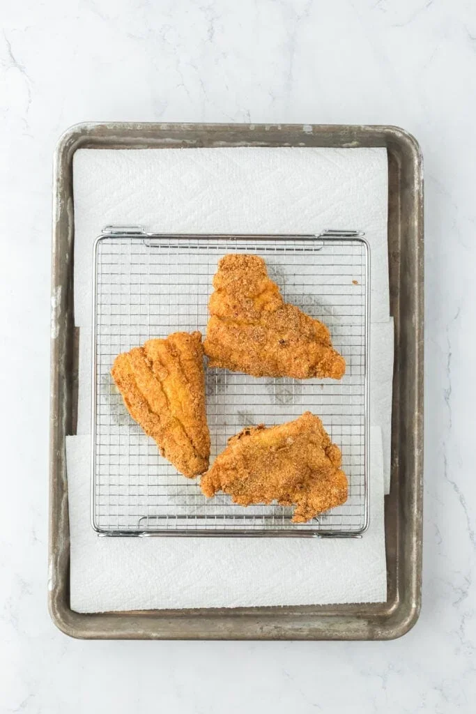 Authentic Mississippi Fried Catfish Recipe That's Crispy & Tender 7 perfectly fried cornmeal cooking in hot oil with golden crust