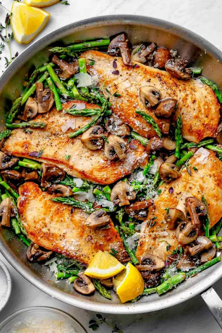 golden brown chicken cutlets with asparagus and mushrooms in lemon sauce