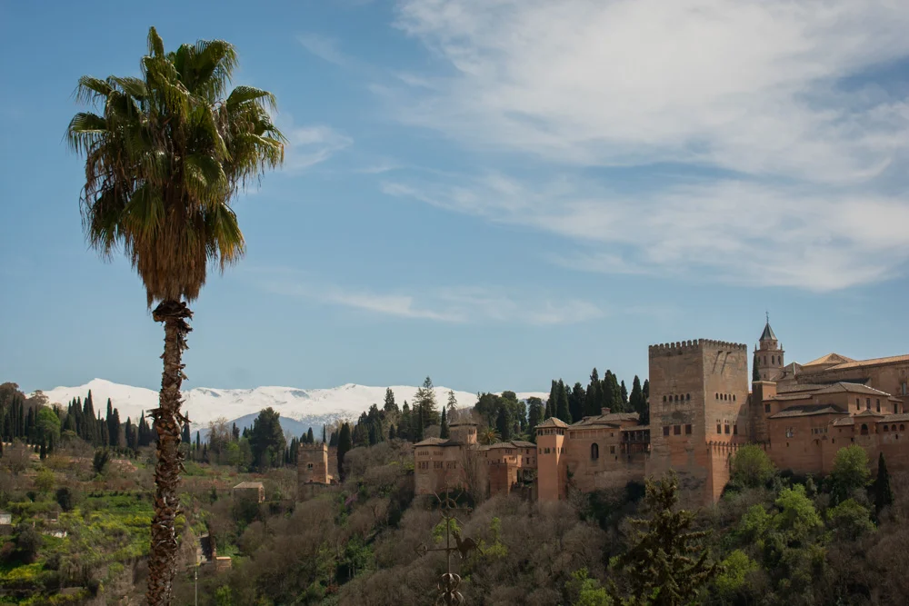 panoramic view of Alhambra palace from Mirador de San Nicolás in Granada at sunset