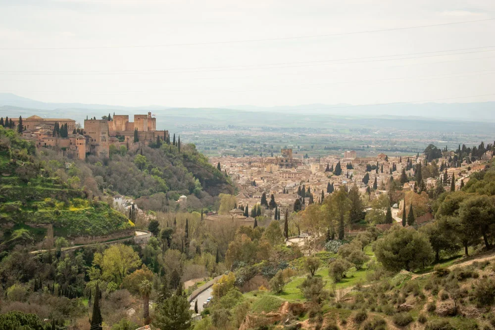 panoramic view of Sacromonte Abbey overlooking Granada's hills and cityscape