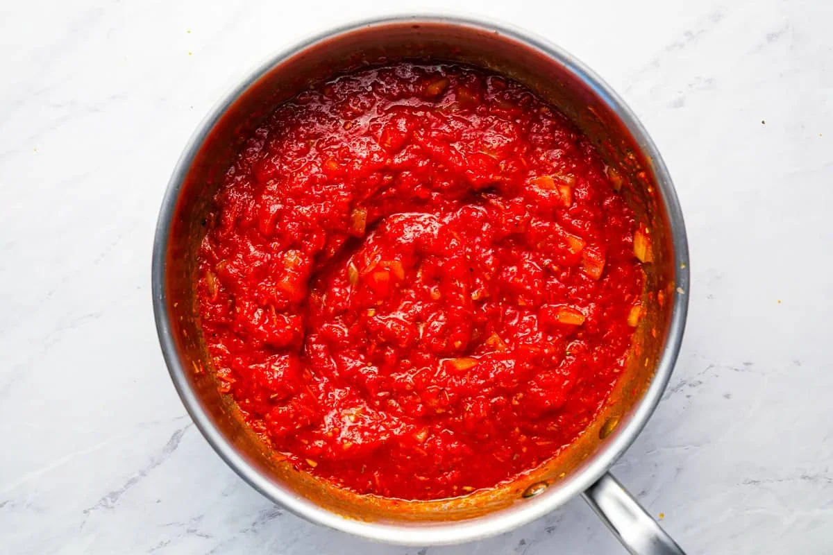Homemade Spaghetti Sauce Recipe - The Cookie Rookie® 4 thick spaghetti sauce simmering on stove with spoon