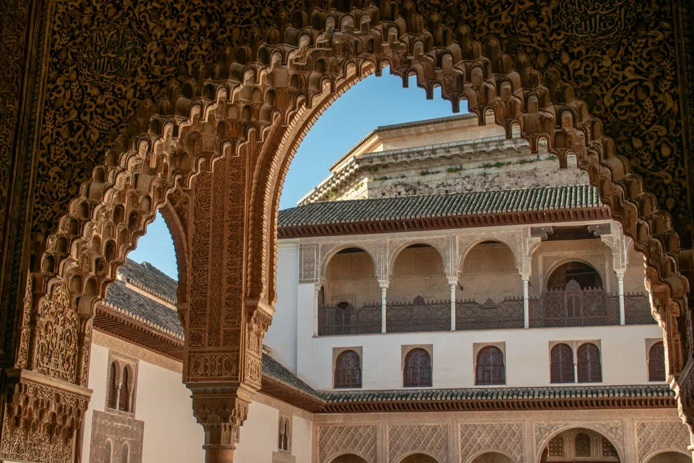 intricate arches and reflecting pool in nasrid palaces granada