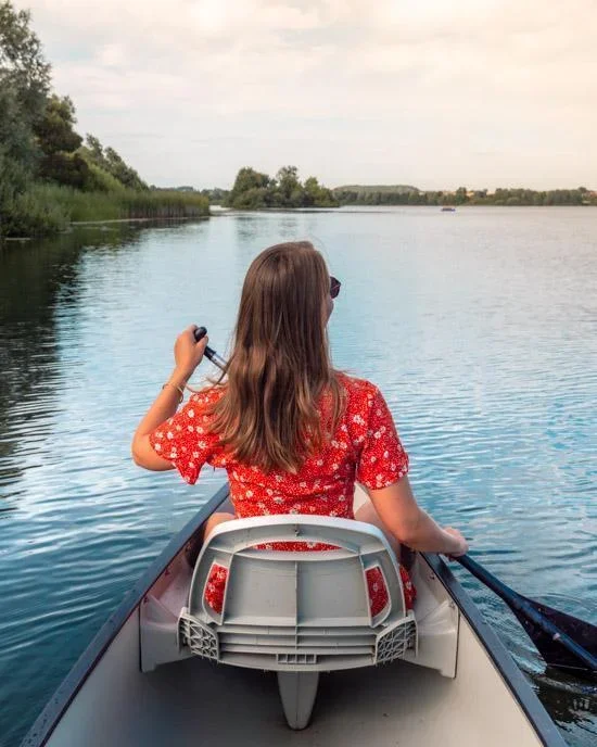 Rented canoe on Kleiner Ploner See with calm water and green shoreline