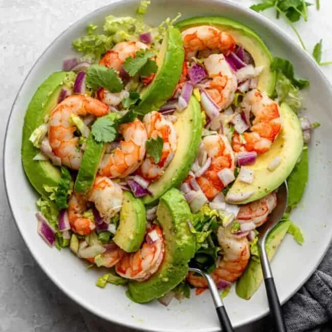 vibrant shrimp avocado salad with lime and cilantro in a white bowl