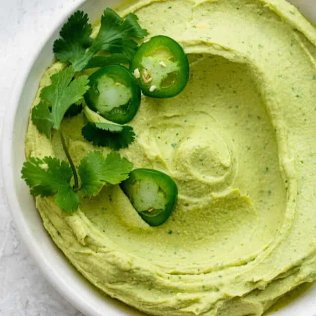 fresh guacamole in stone bowl with tortilla chips