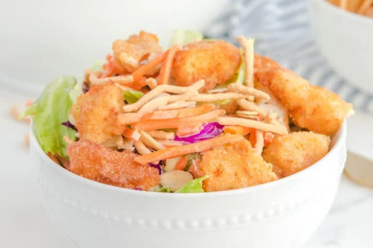 17 Spring Brunch Salads That Feel Fresh 15 Crispy Asian chicken salad with sesame dressing on a white plate