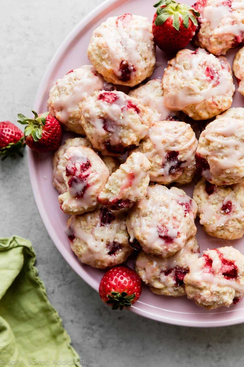 Ingredients for strawberry biscuit cookies arranged on counter including flour, cold butter, and chopped strawberries
