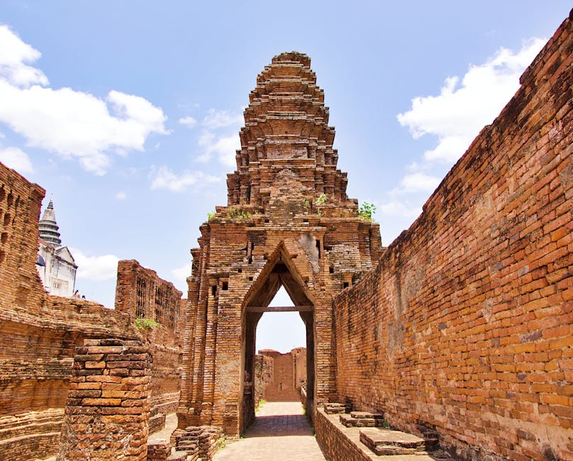 Ayutthaya Travel Guide: History, Food & Hidden Gems 8 Cyclist riding past Wat Phra Si Sanphet ruins