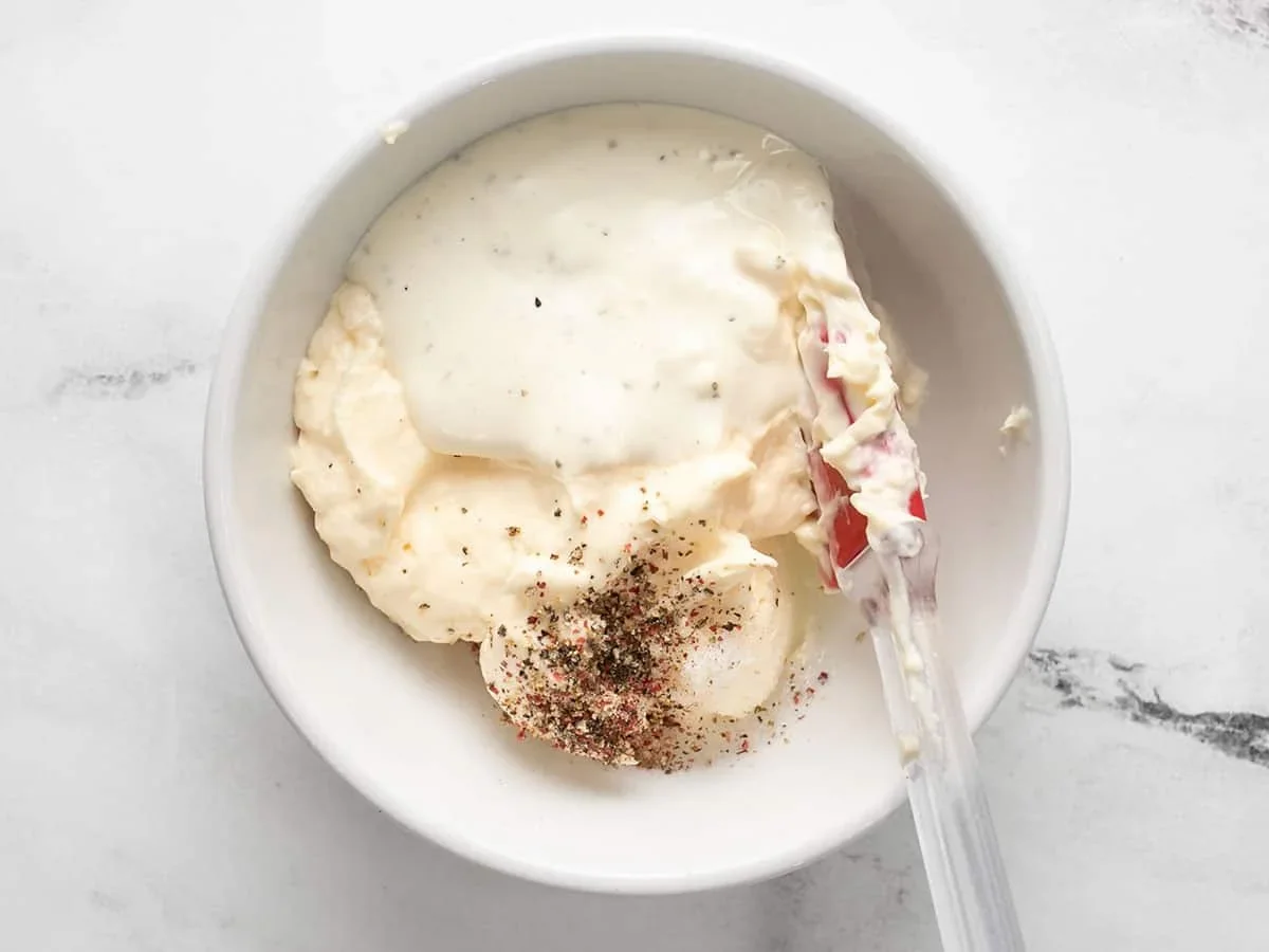 creamy mayonnaise and ranch dressing whisked together in a bowl