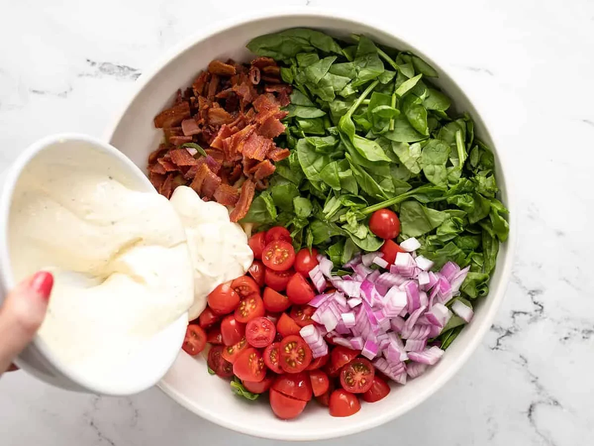 blt pasta salad combines creamy mayo-ranch dressing with crispy bacon, fresh tomatoes, and spinach for the perfect summer side dish. This easy recipe is ideal for BBQs, picnics, and potlucks. Make it now!