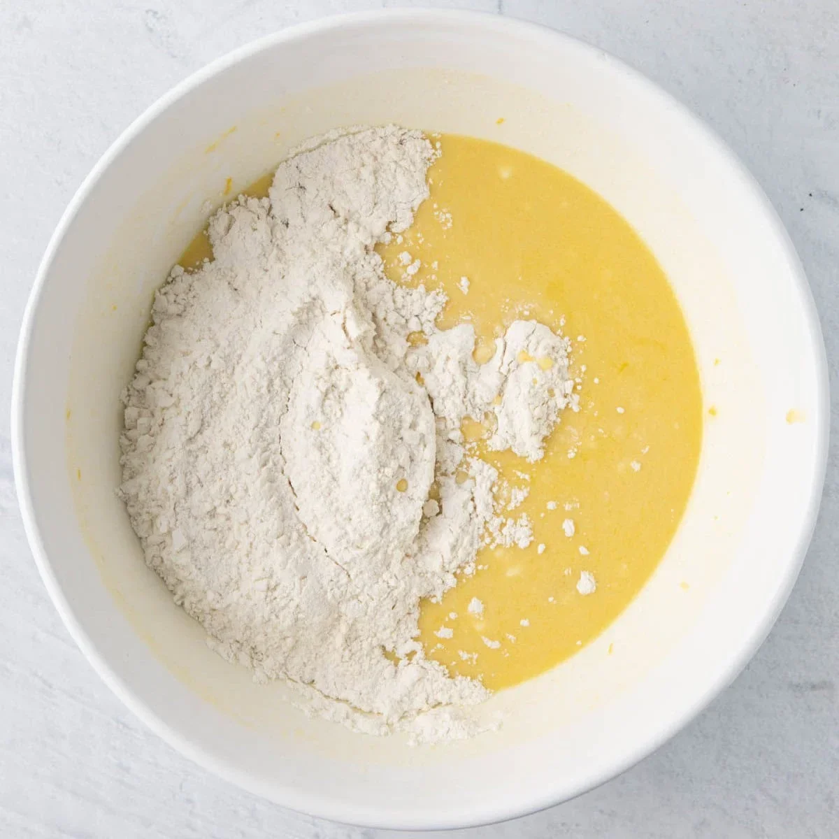 Easy Lemon Ricotta Cake Recipe with One-Bowl Simplicity 4 lemon ricotta cake made with fresh lemon zest, ricotta cheese and olive oil for a soft, moist texture. This one-bowl recipe requires no frosting and is perfect for spring. Try it tonight!