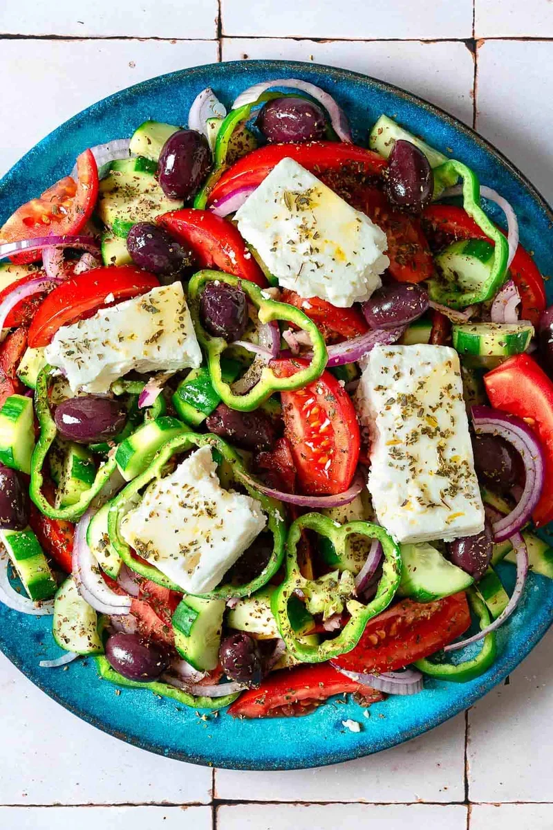 Authentic Greek Salad Recipe That's Easy and Delicious 5 completed traditional Greek salad with block feta cheese and Kalamata olives