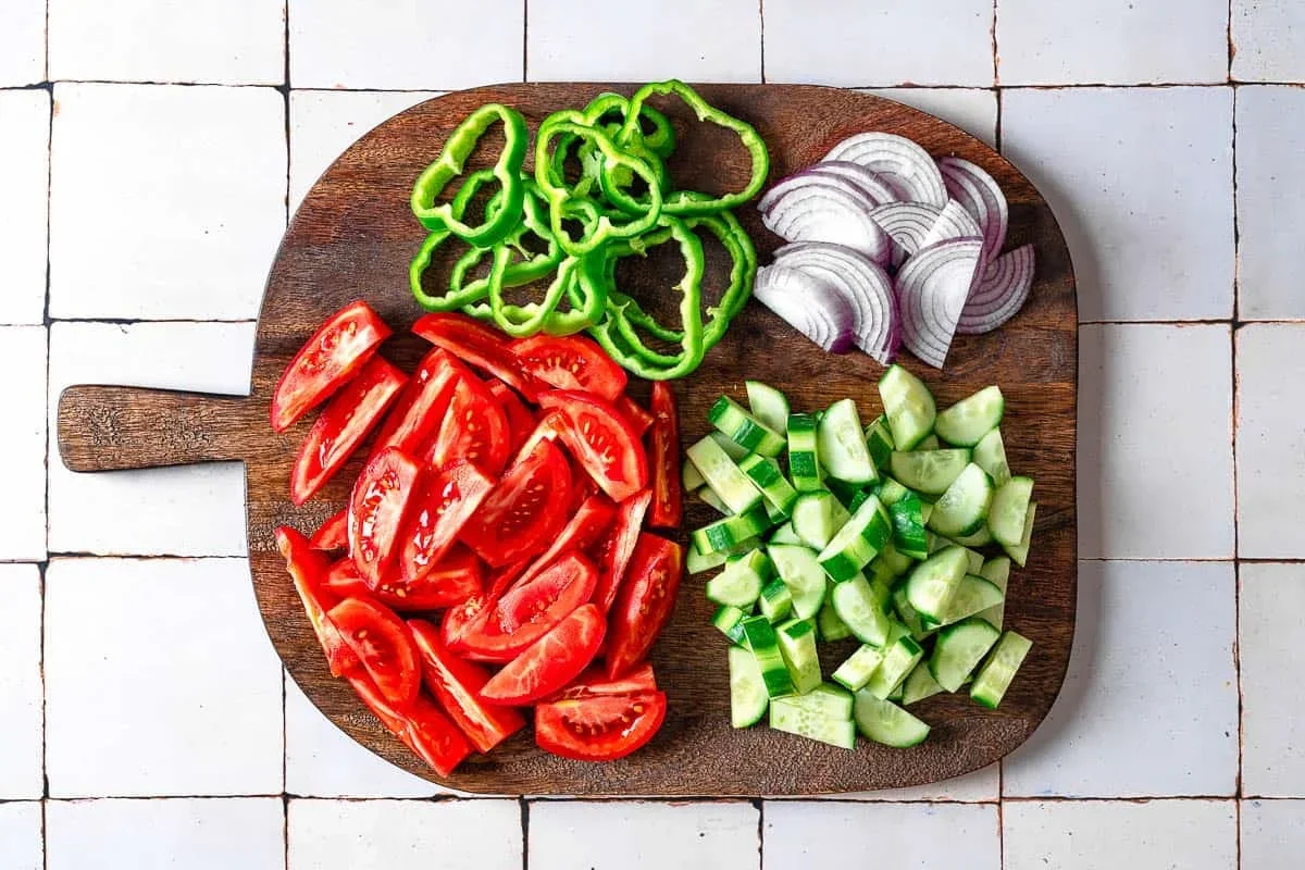 Authentic Greek Salad Recipe That's Easy and Delicious 3 red onion slices soaking in ice water for Greek salad preparation
