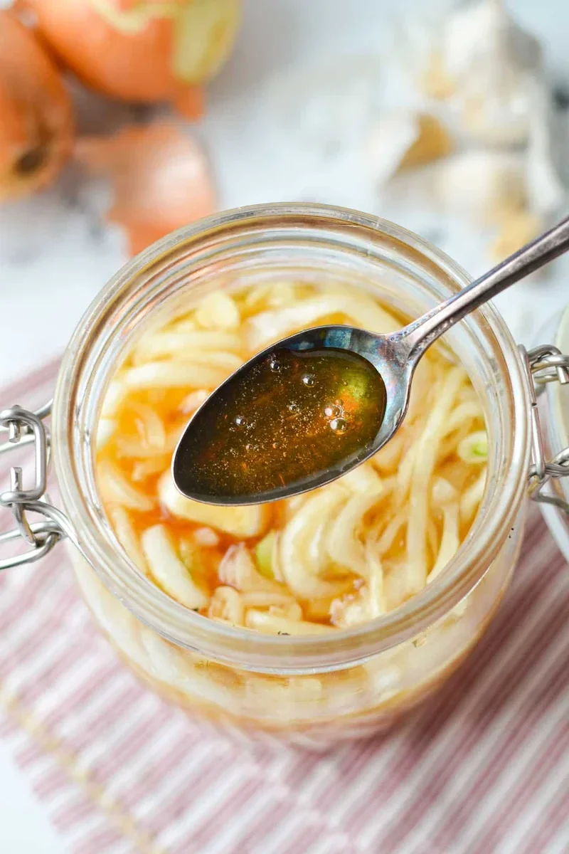 Easy Honey Onion Cough Syrup Recipe That Actually Works 5 strained honey onion cough syrup in glass mason jar with lid