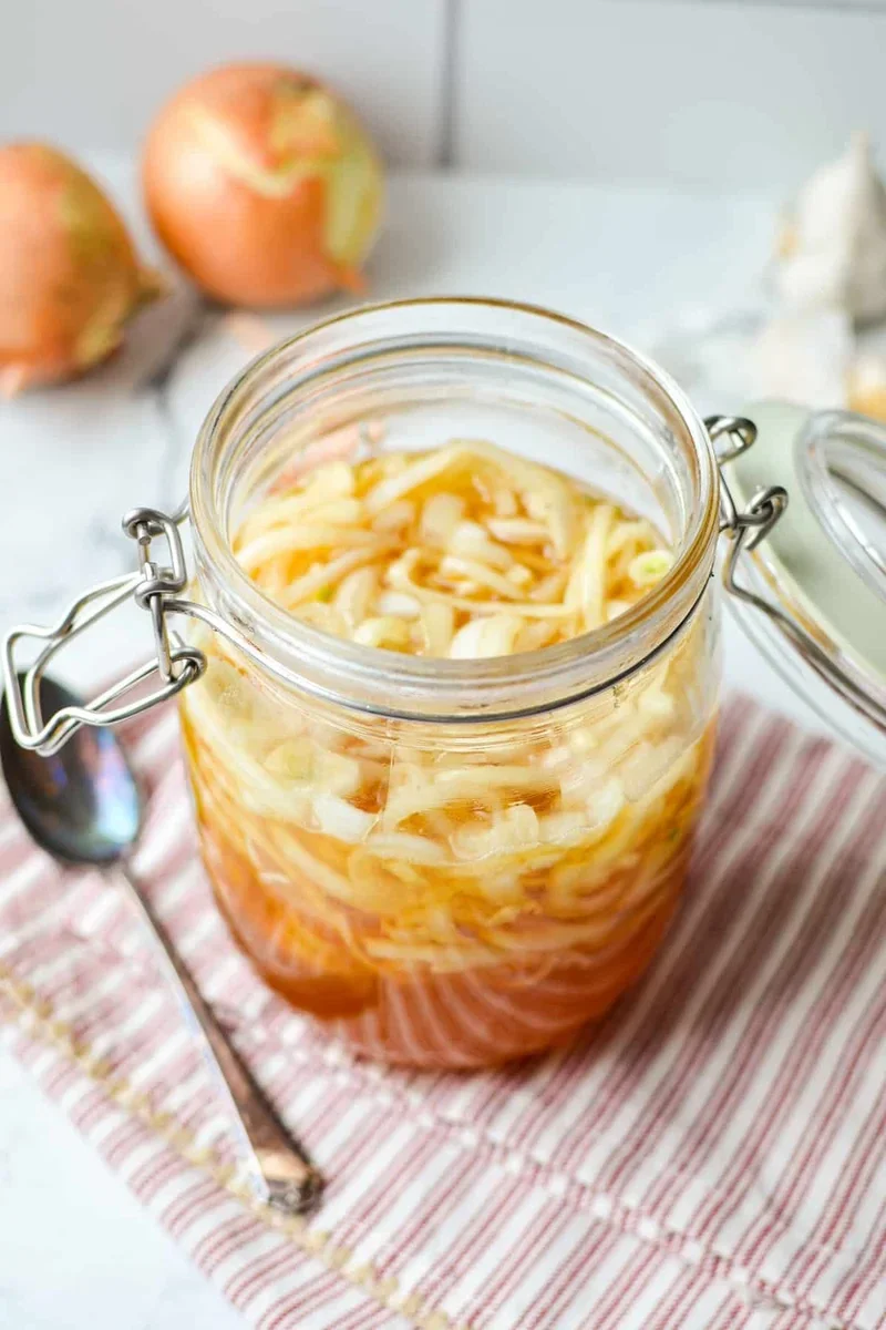 Easy Honey Onion Cough Syrup Recipe That Actually Works 7 three small jars showing honey onion syrup with lemon, ginger, and maple syrup variations