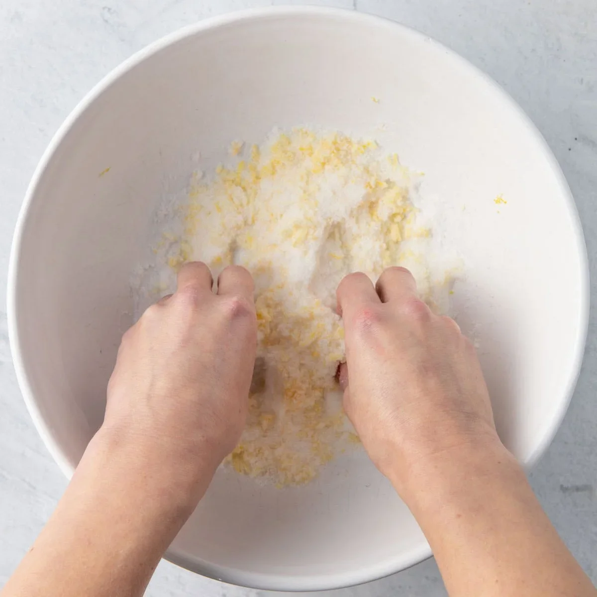 Easy Lemon Ricotta Cake Recipe with One-Bowl Simplicity 2 close-up of rubbing lemon zest into sugar for lemon ricotta cake