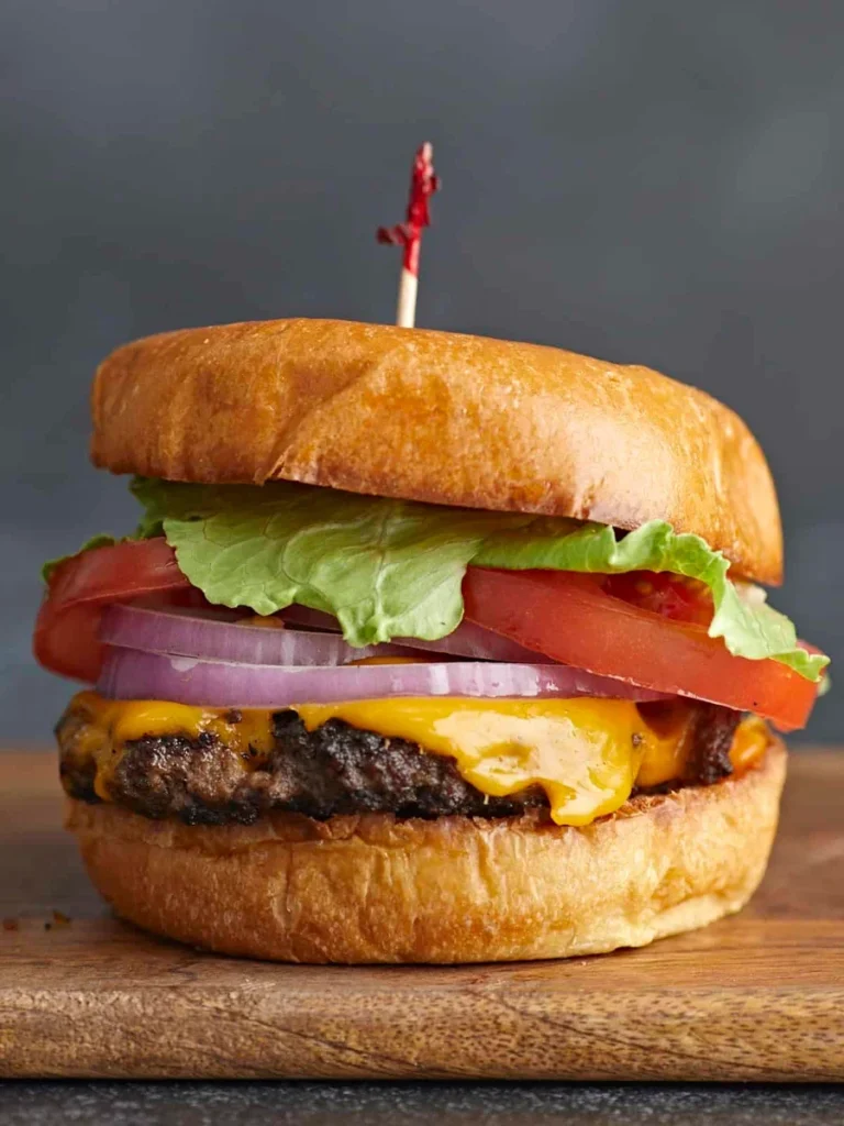 crispy smash burger patty with melted cheese in a cast iron skillet