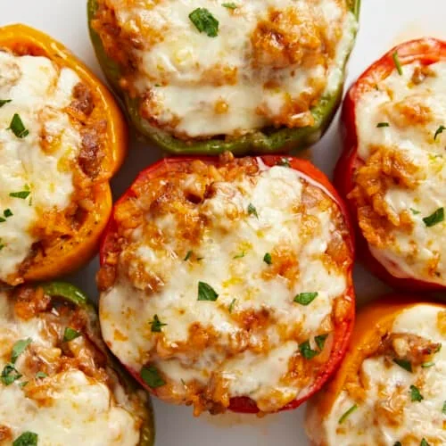 raw stuffed bell peppers with Italian sausage and rice filling ready for baking