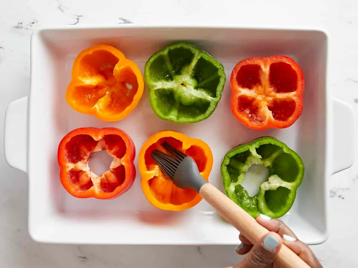 pre-baked bell pepper halves in a casserole dish before stuffing
